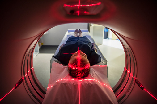 Patient lying inside a medical scanner in hospital