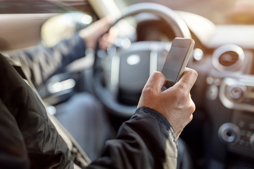 Texting while driving using cell phone in car