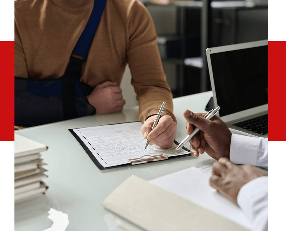 An injured man filling out a document