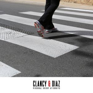 A pedestrian in Benicia in using the crosswalk