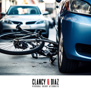 A crushed bicycle lying in the road next to a car after a Brentwood bike accident
